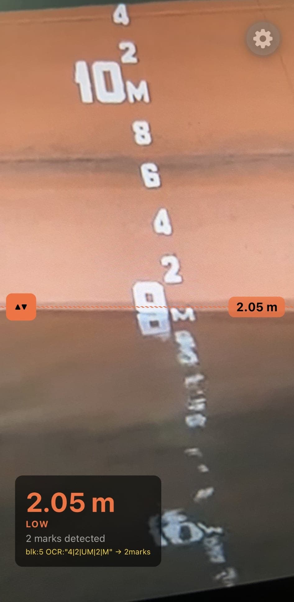 The draft-survey app reading 2.05 metres from a ship hull, showing two marks detected and the raw OCR output.